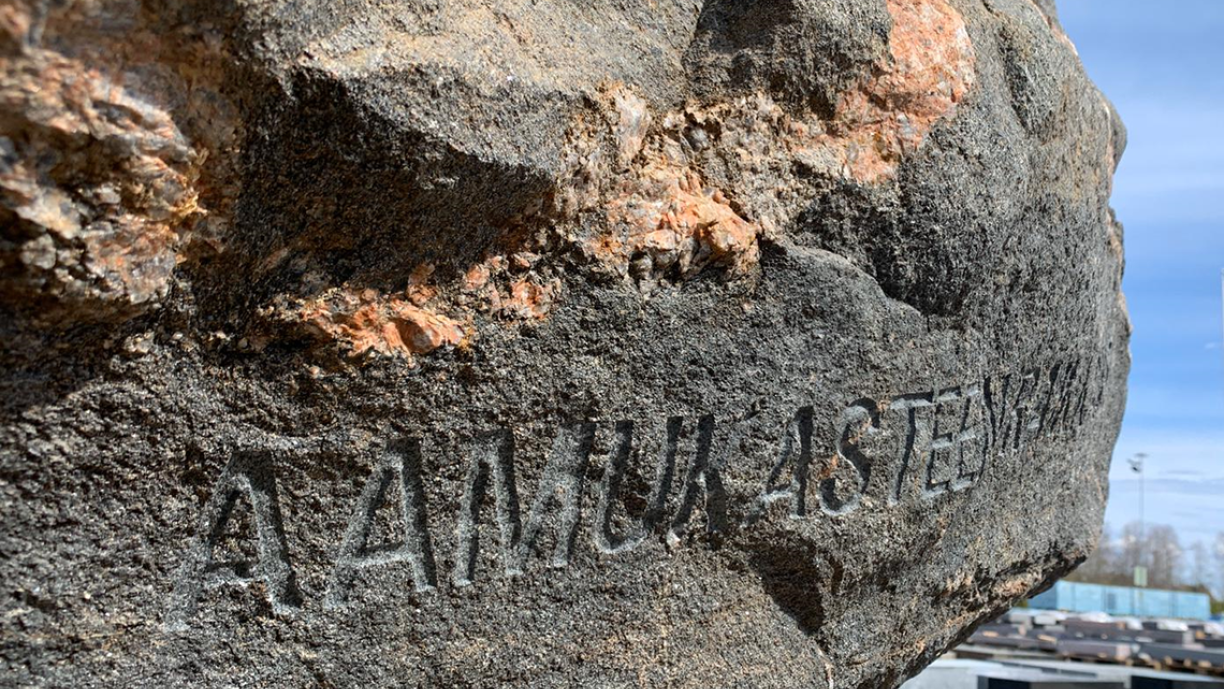 Suuri kivi, johon on kaiverrettu teksti aamukasteen raikkaus.
