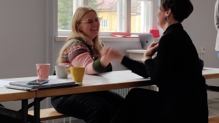 Rento tilannekuva nauravista Tiina Purasesta ja Susanna Mäki-Oversteynsista Lottaliina Pokkisen työpajassa vääntämässä pöydän ympärillä kahvikuppien kanssa.